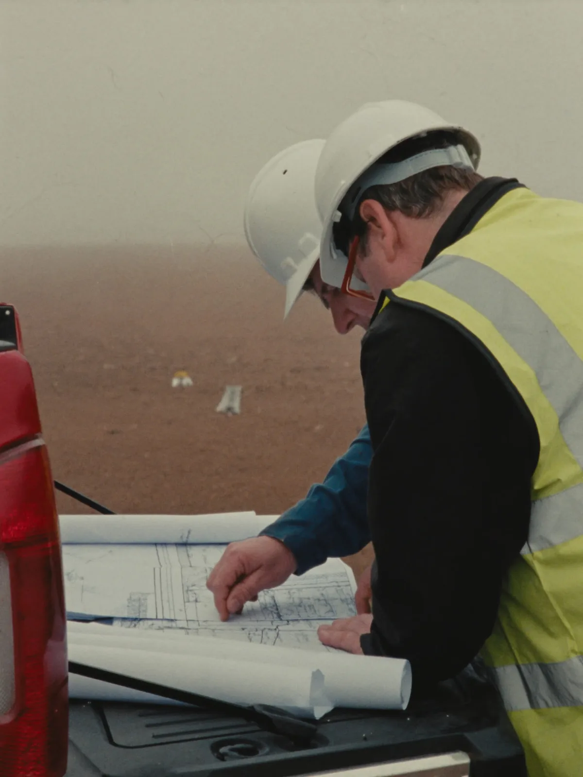 Merlot Civil engineering crew reviewing site drawings on location